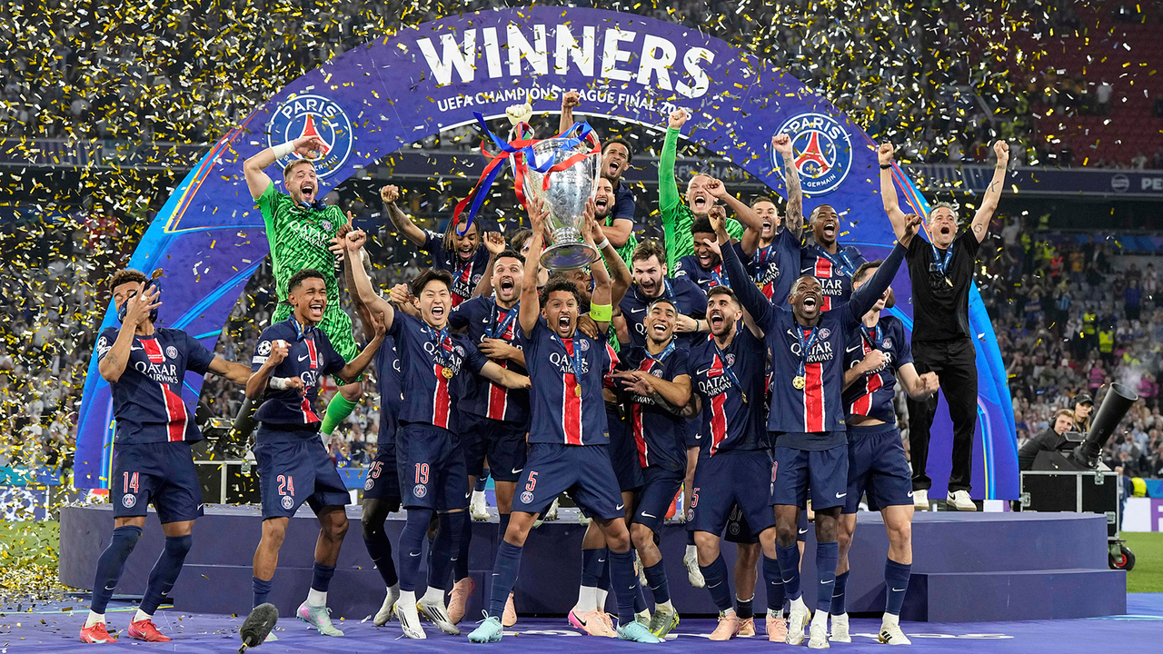 PSG's Marquinhos holds up the trophy as he celebrates with his teammates after winning the Champions League final soccer match between Paris Saint-Germain and Inter Milan at the Allianz Arena in Munich, Germany, Saturday, May 31, 2025. (AP Photo/Martin Meissner)